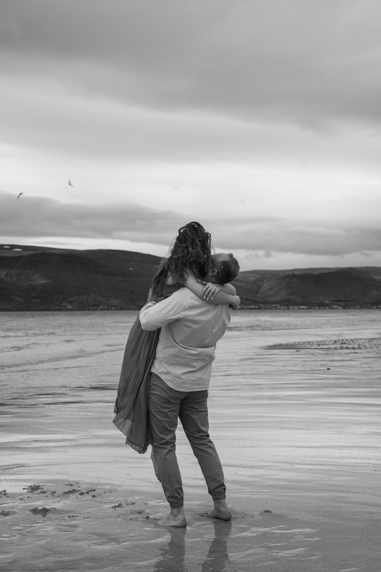 Romantic moment between couple at Iceland’s dramatic fjords