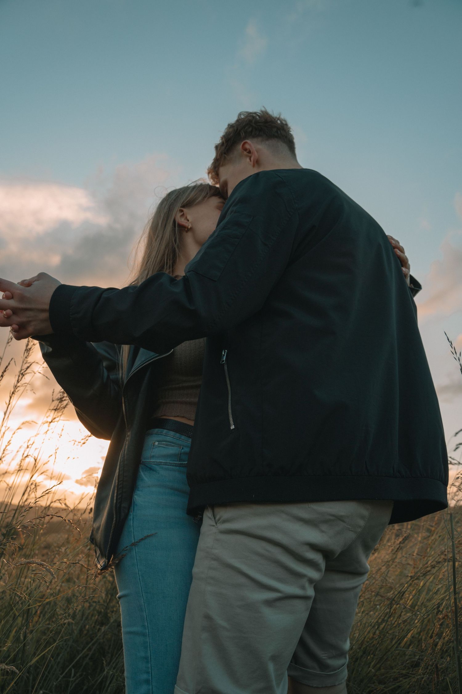 Couple walking through the Scottish Highlands during golden hour