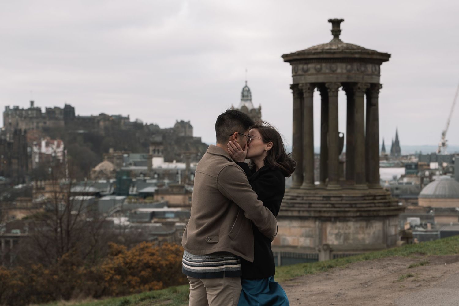 Emotional surprise proposal captured at Calton Hill