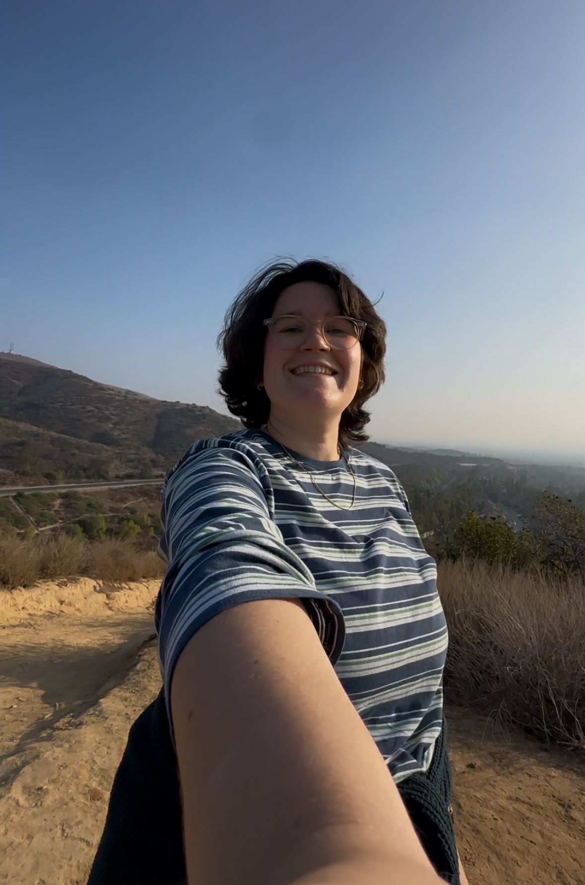 A selfie taken on a hiking trail overlooking mountains and valleys on a clear sunny day. My everyday life