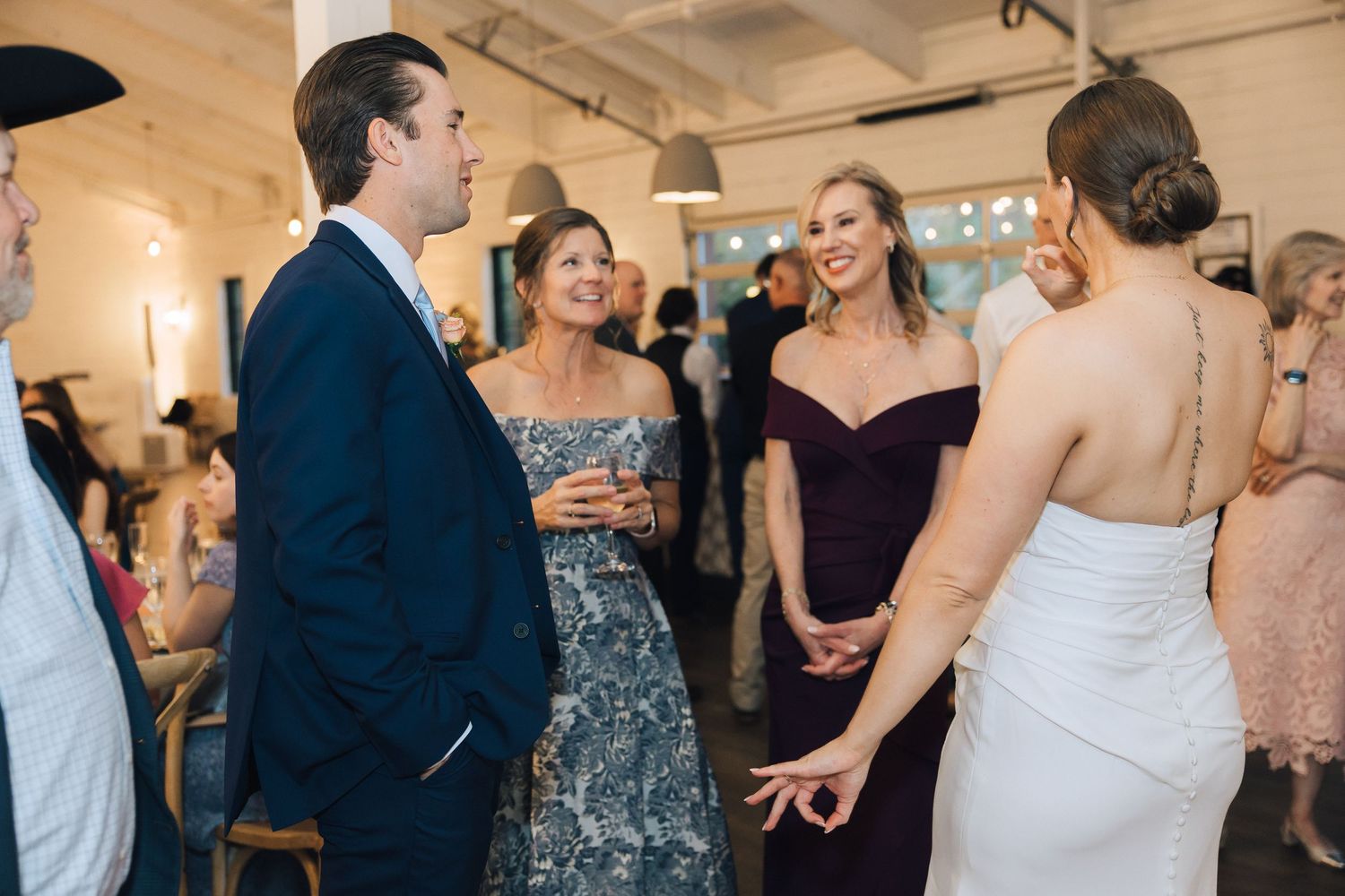 Celebration in a bright modern venue with guests enjoying themselves on a dance floor.