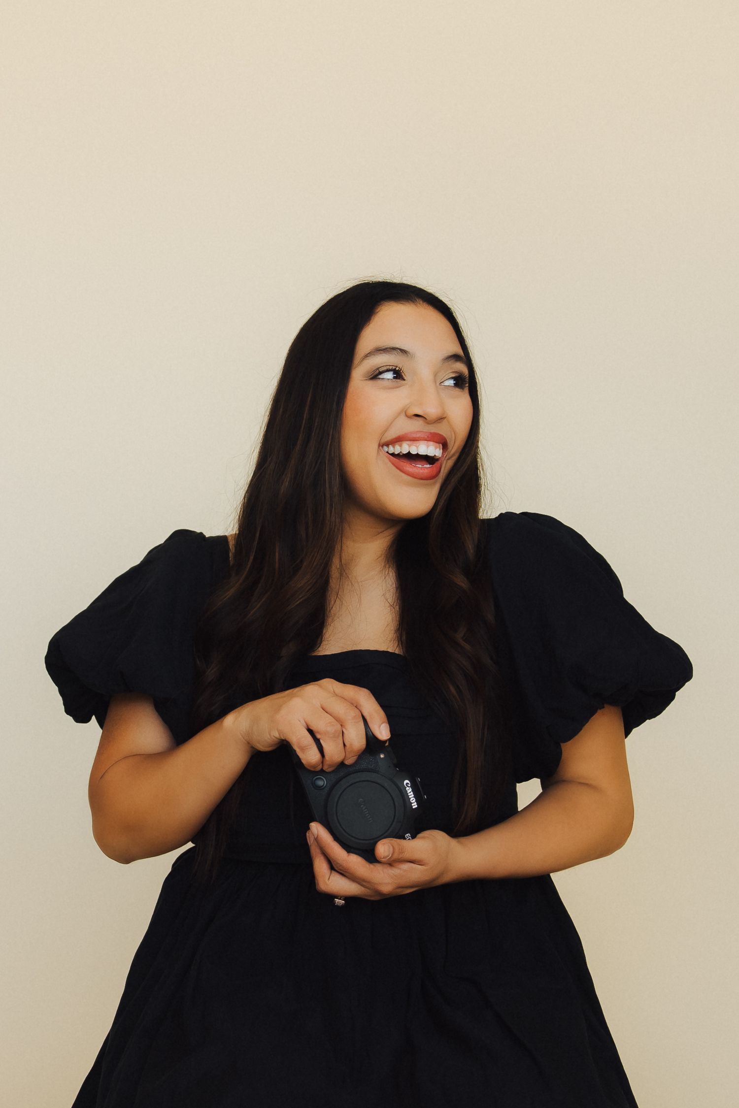 A series of four expressive poses in black attire against a light background shows joyful and dynamic movement.