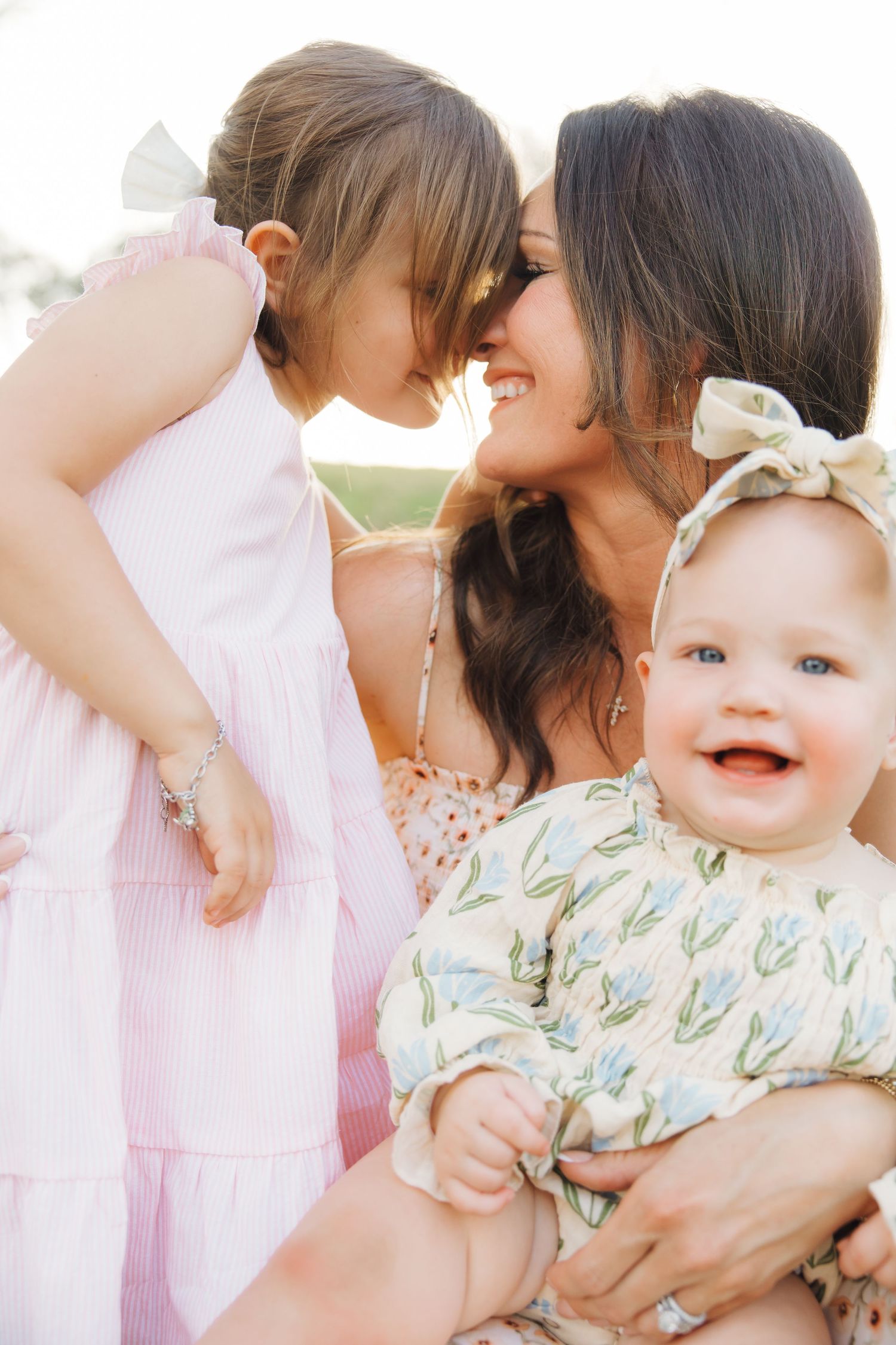 Happy family members share loving moments and smiles together in a series of candid outdoor photos.