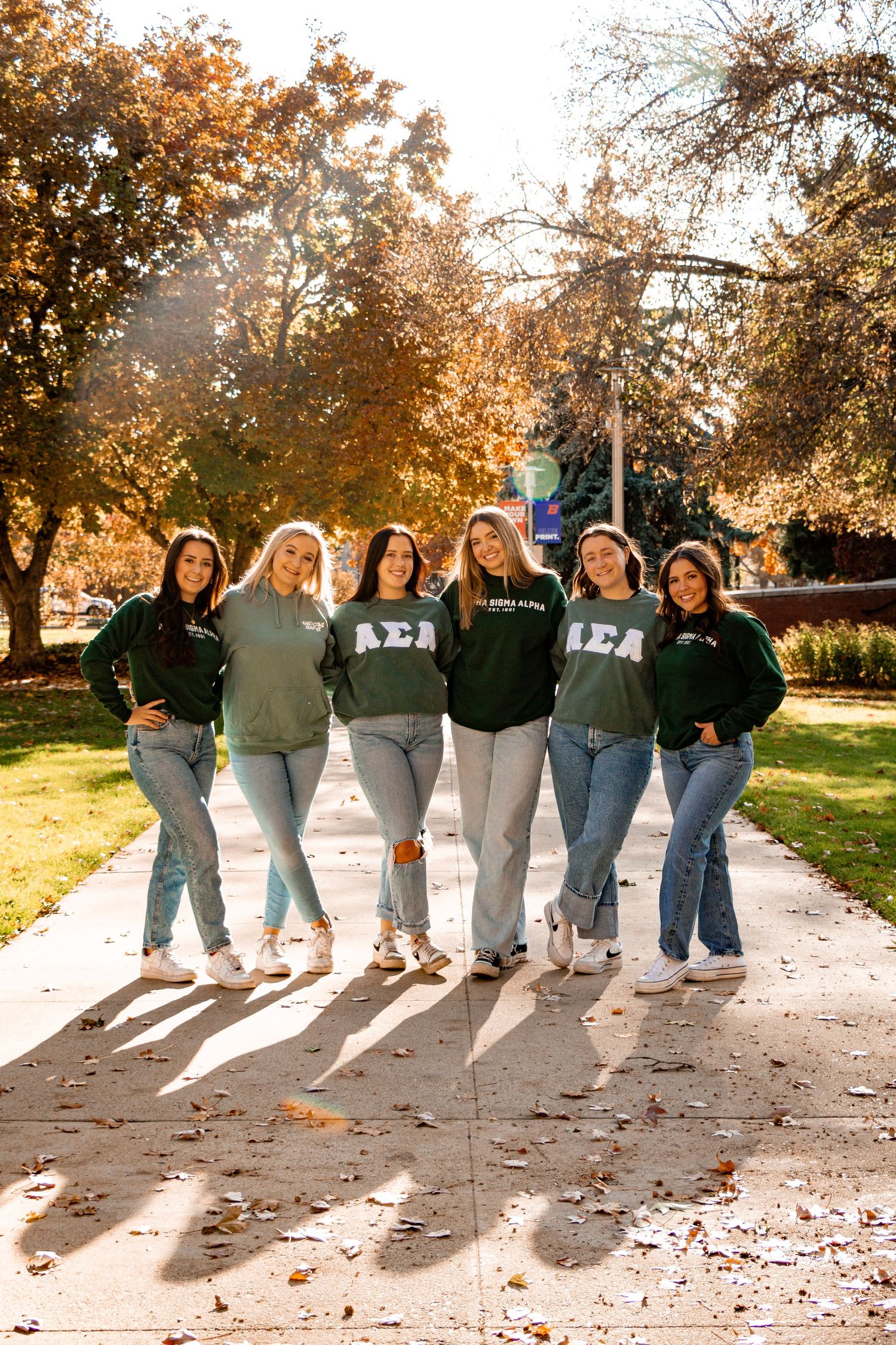a group of grads posing for a photo in fall weather