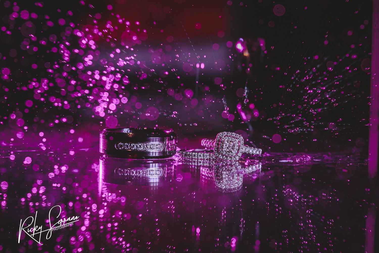 Magical purple lights illuminate floating ice cubes in dark water creating a dreamy reflection effect.