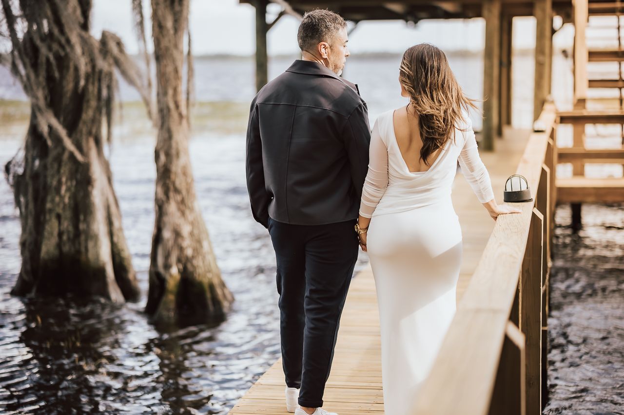 Engaged couple smiling at sunset in romantic outdoor location
