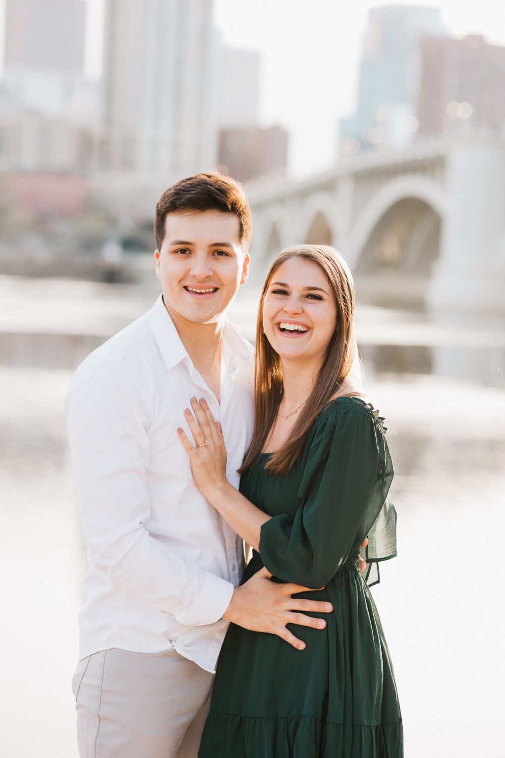 Engagement announcement moment captured by Stone Arch Bridge in Minneapolis.