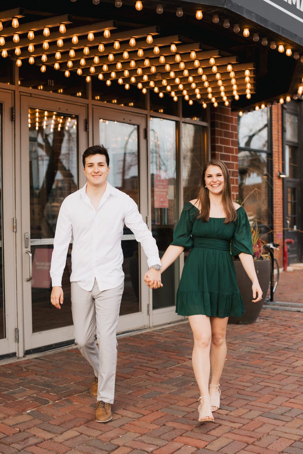 Series of photos on brick pavement showing couple in white and green outfits walking playfully.