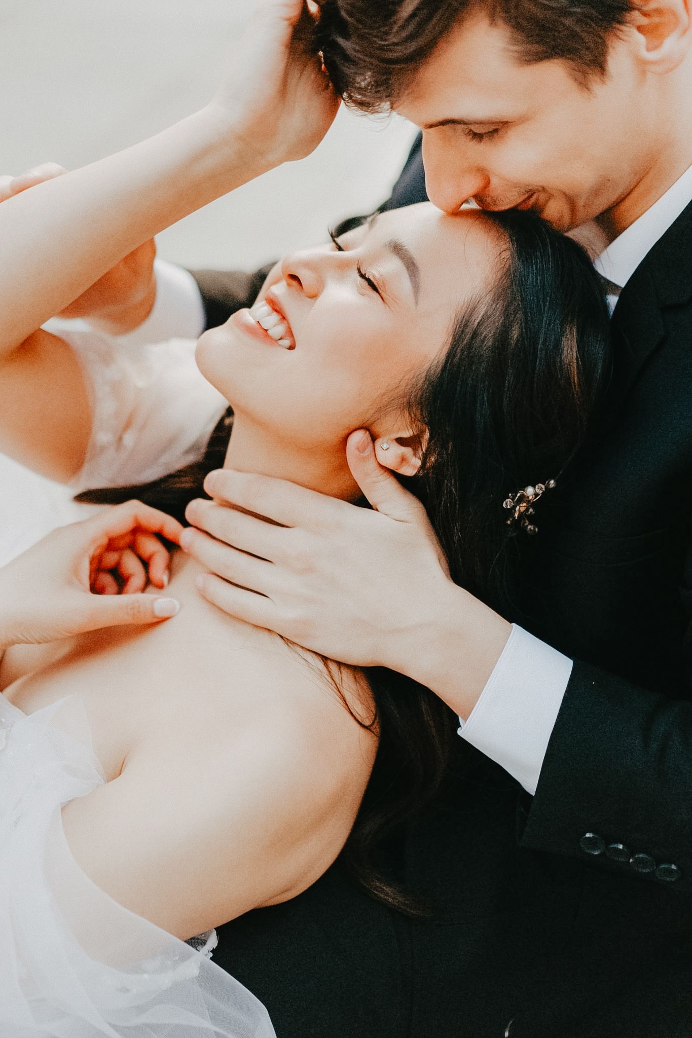 Editorial coverage of a Wedding Couple with bright whites and a close up on their faces.