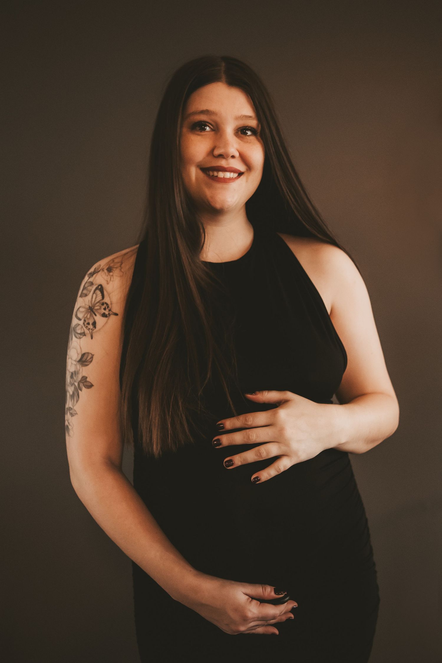 Woman holding pregnant belly with twins inside