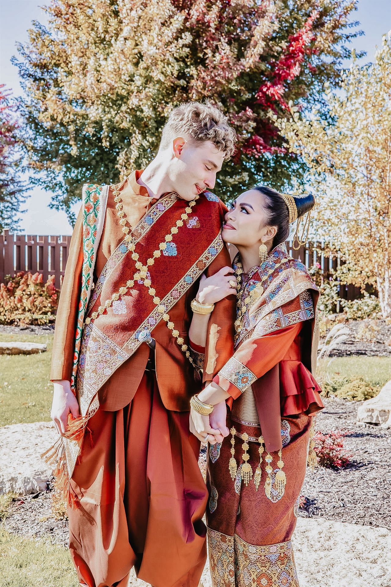 Modern Laotian wedding couple portrait outdoors, blending traditional elegance with contemporary style — captured in natural light with a br