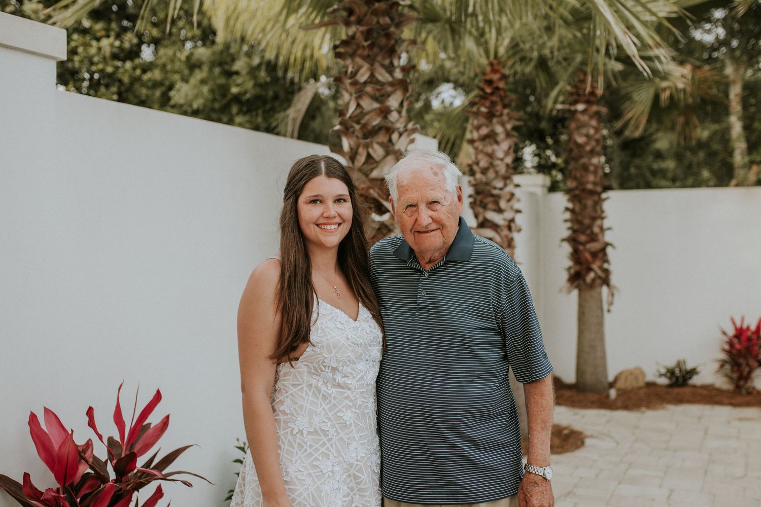 Destination beach ceremony with neutral florals, captured in soft film tones with a modern edge