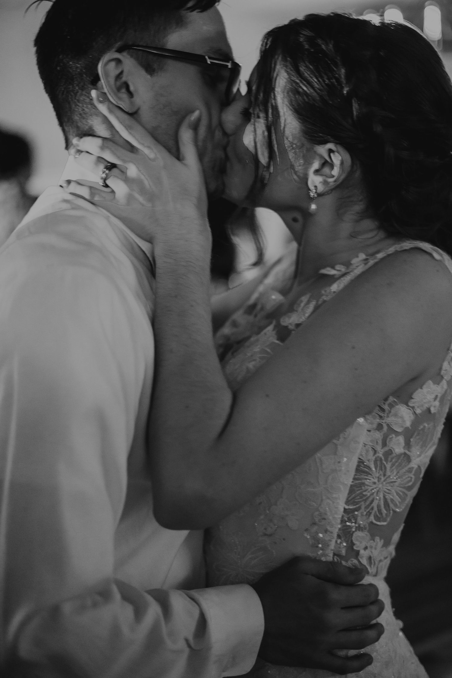 Intimate documentary-style photo of a couple sharing a tender kiss, captured on film with soft natural light and a timeless, cinematic feel