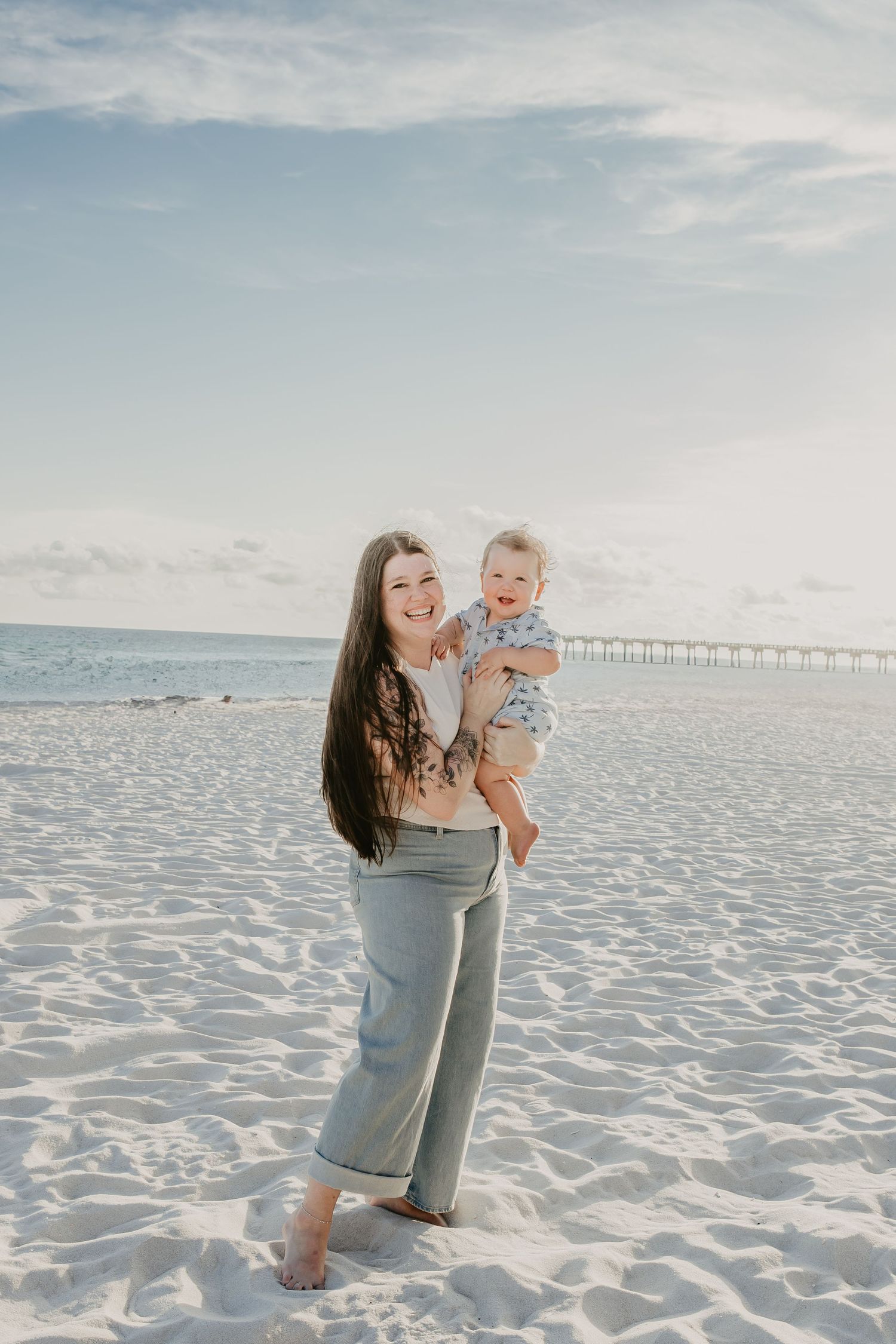 Woman holding baby boy on beach