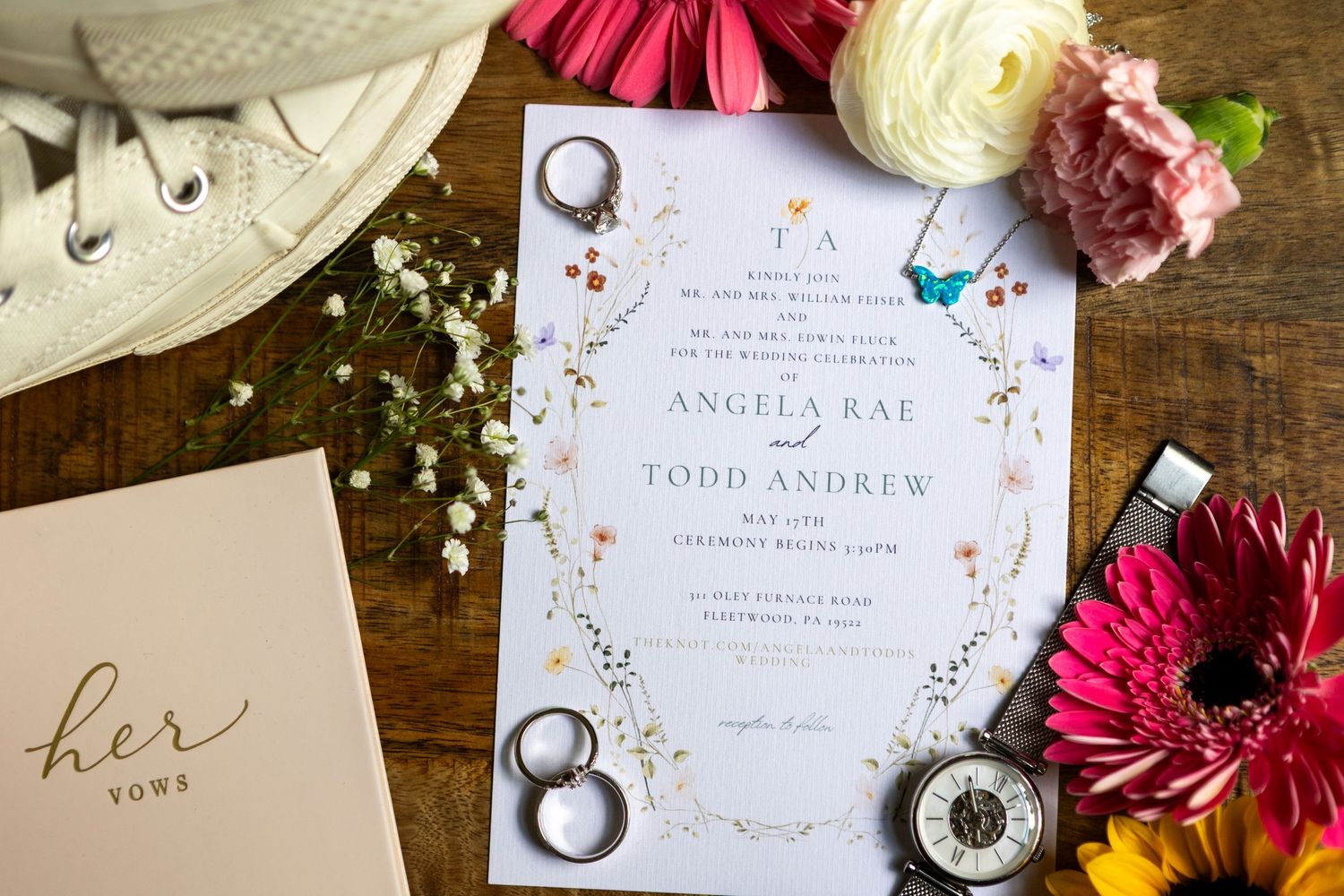 Editorial flat-lay of wedding rings on muted green linen at Birmingham, AL wedding