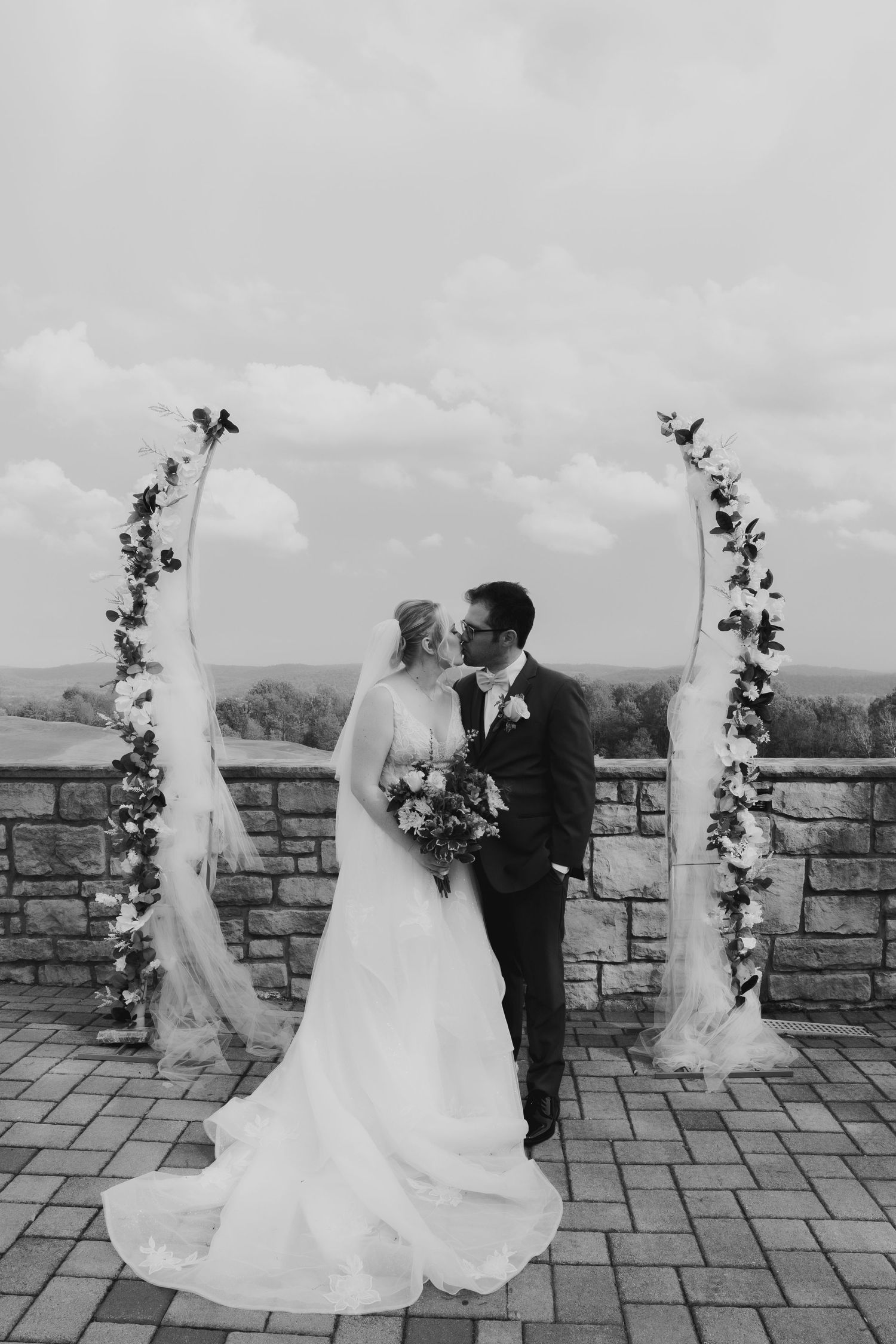 Couple's first kiss in Easton, PA, editorial wedding photography with a soft film aesthetic in black and white.