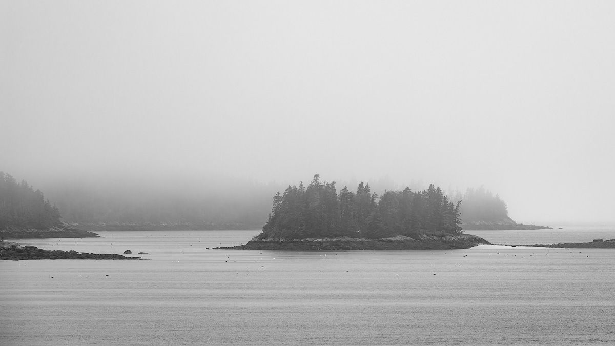 Minimalist seascape with foggy islands in Maine.