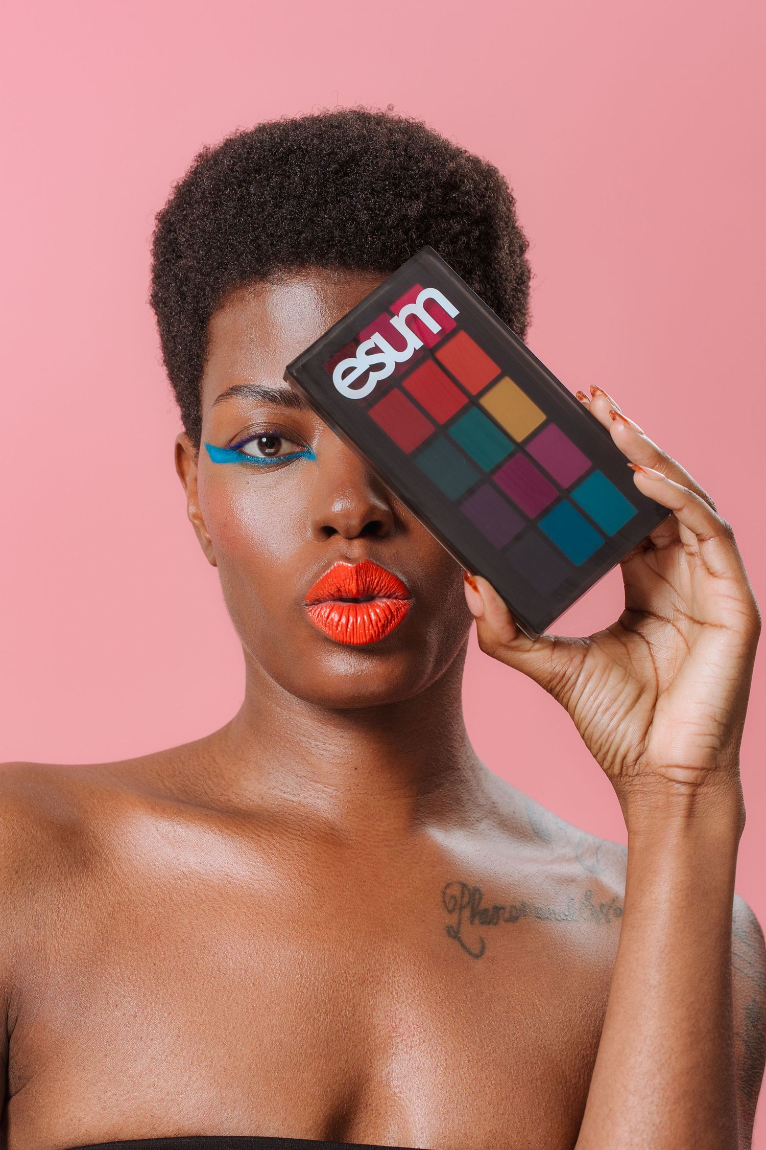Editorial beauty portrait with red lips, blue eyeliner, and bold eyeshadow palette – NYC creative shoot.