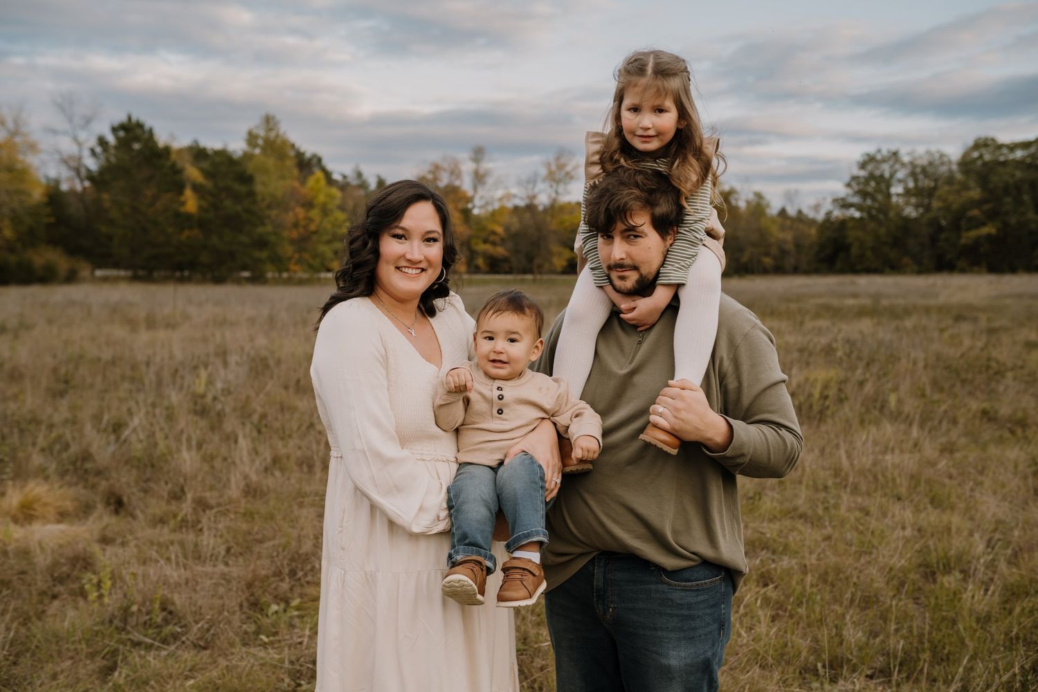 Family of four smiles at the camera