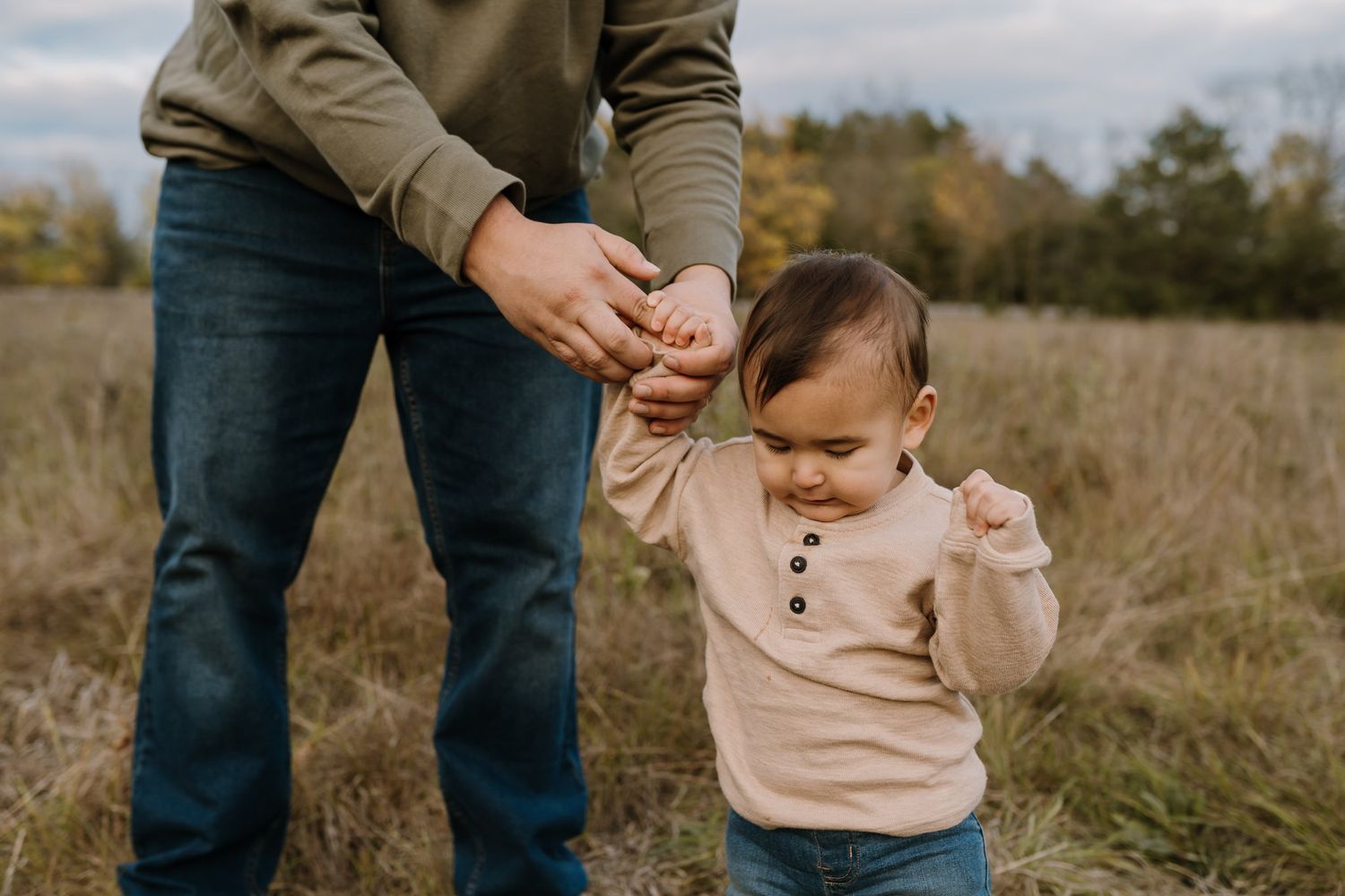 Dad holds toddler's hand