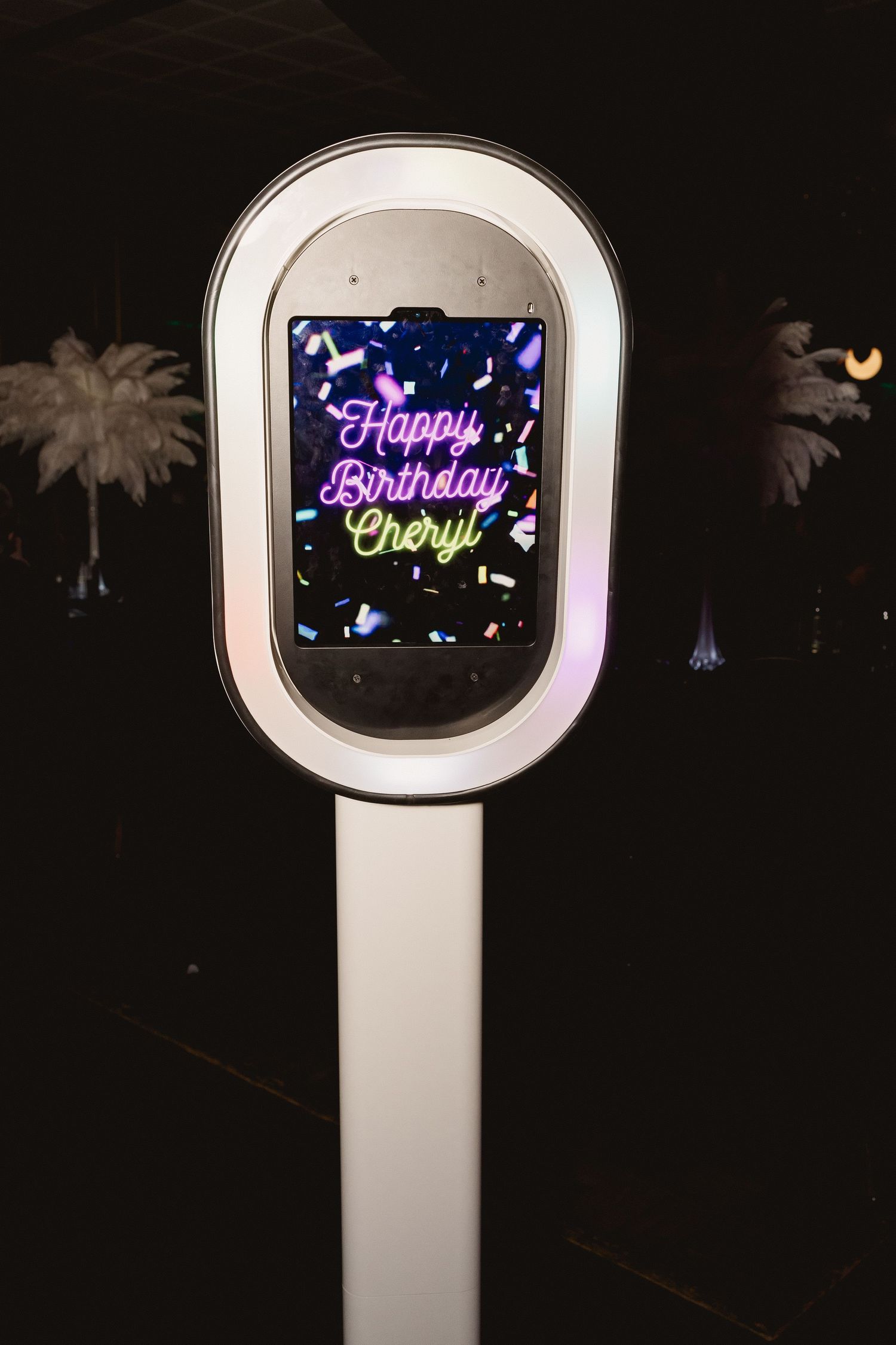 Digital photo booth display showing 'Happy Birthday Cheryl' message with colorful animated effects.