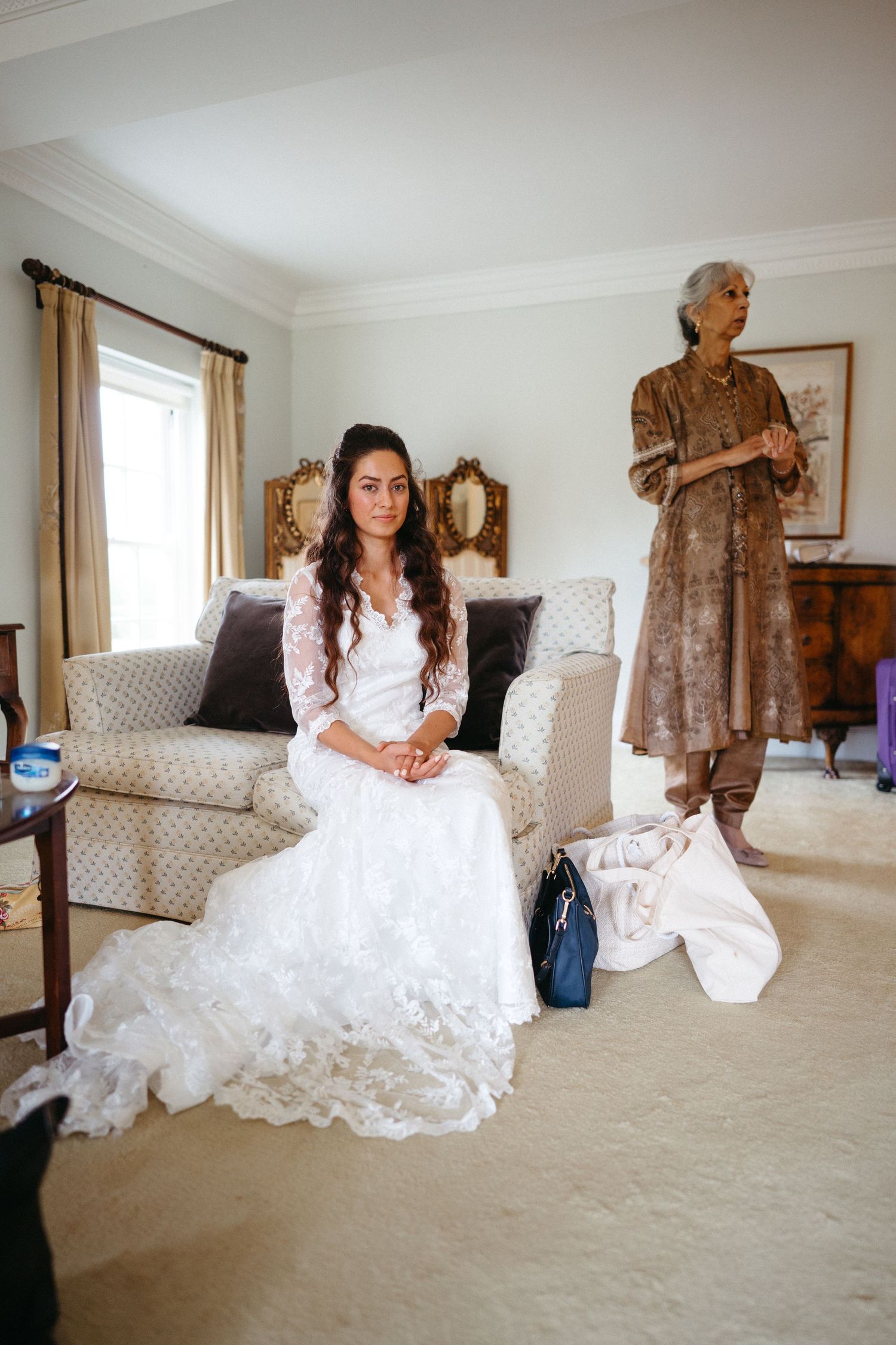A bridal preparation room with elegant white furniture and soft lighting.
