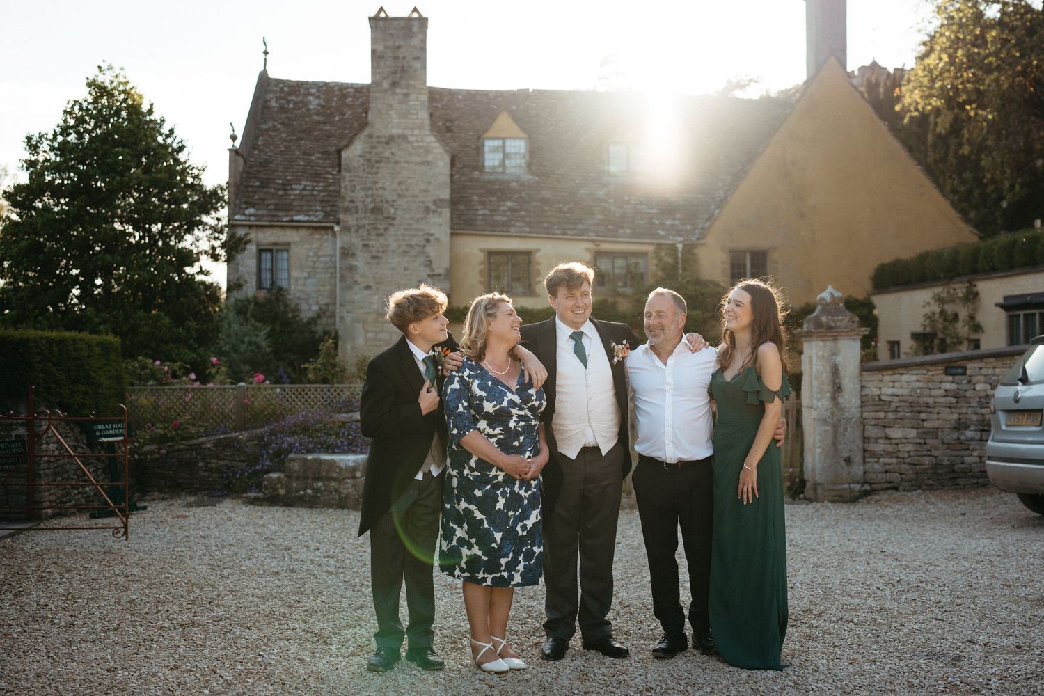 Stone cottage at sunset with group gathering in courtyard for a special occasion.