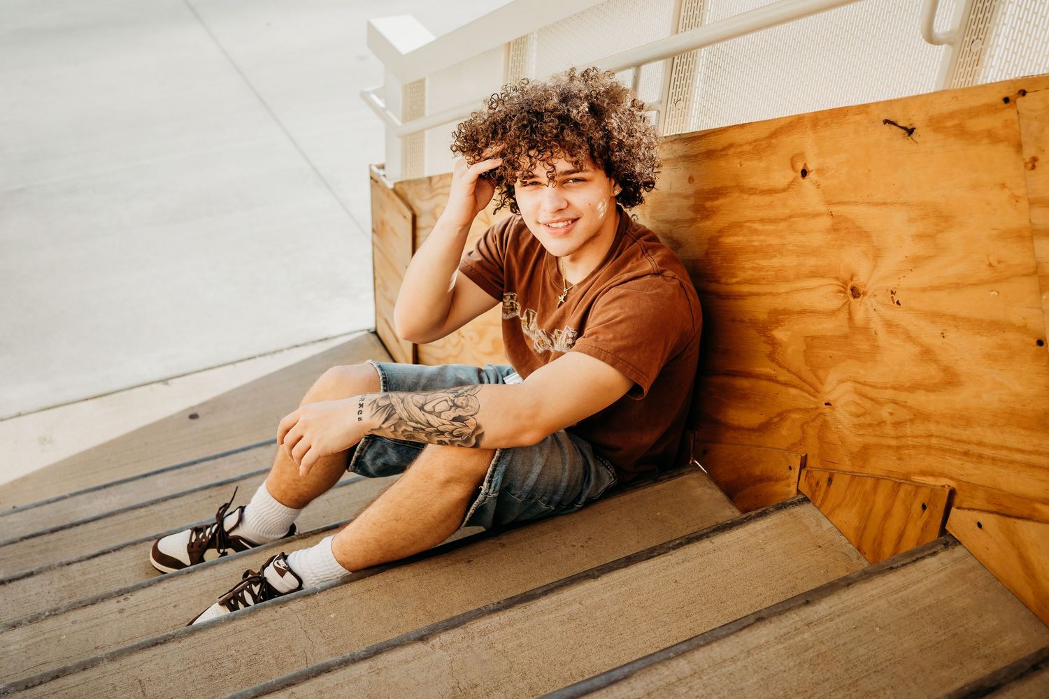 boy senior photography session in bentonville arkansas by crystal bridges on stairs at sunset by best photographer in Bentonville, Arkansas