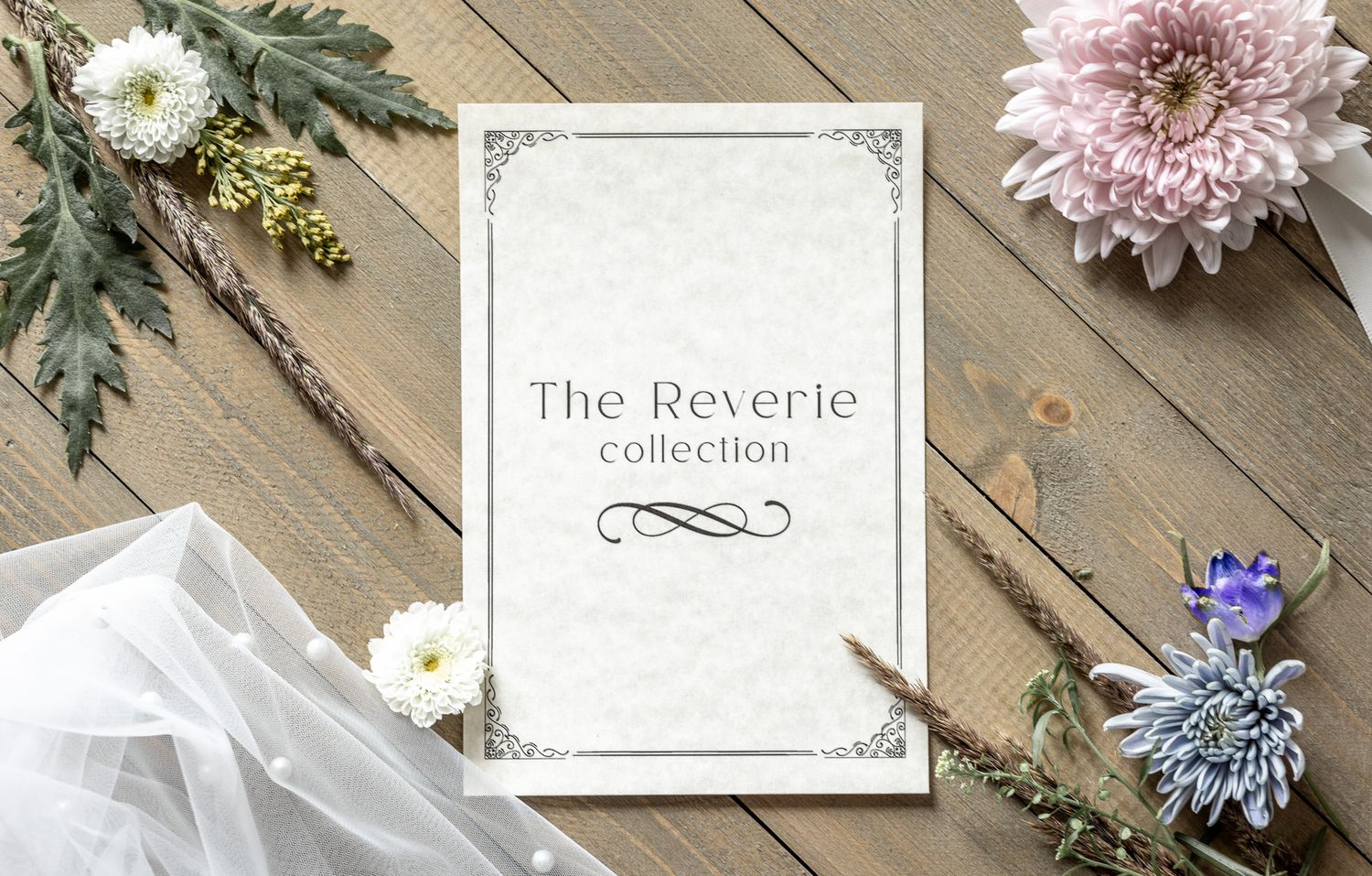 Delicate floral arrangements with pink chrysanthemums and white flowers on rustic wooden boards with elegant stationery.