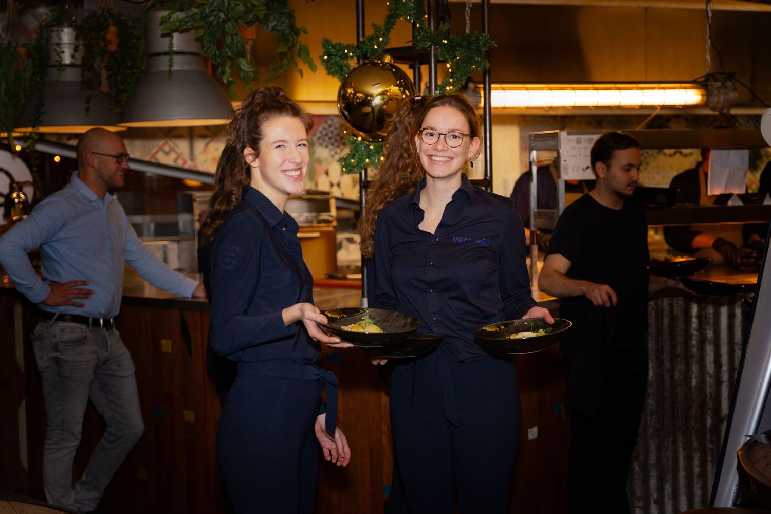 2 dames met eten in de hand in een restaurant