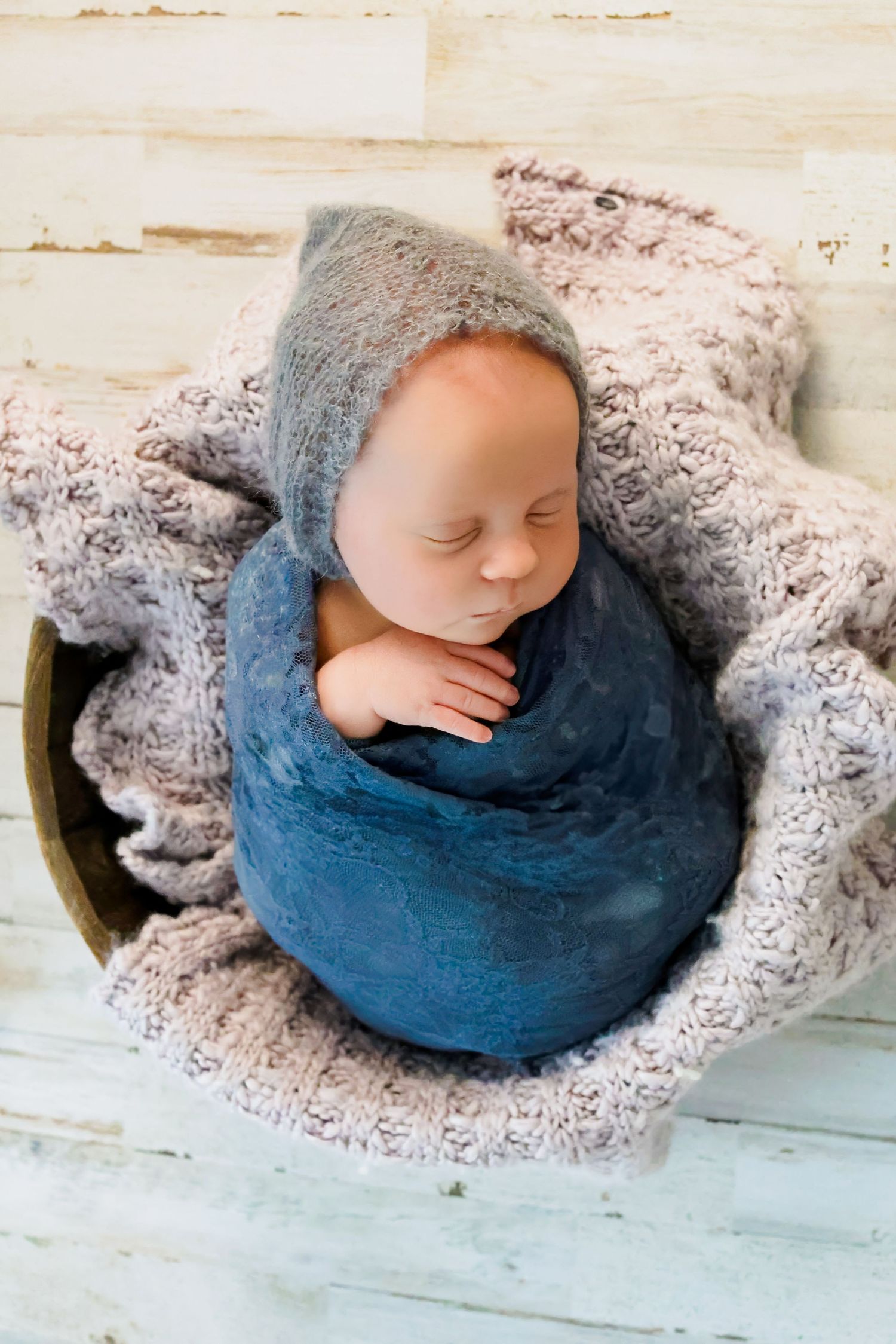 newborn-in-blue-sleeping-in-basket-studio-photoshoot-bend-oregon