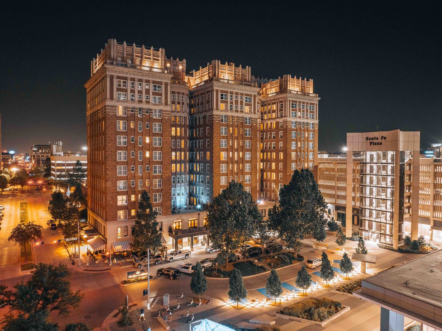 Historic art deco apartment building illuminated at night with ornate architectural details.