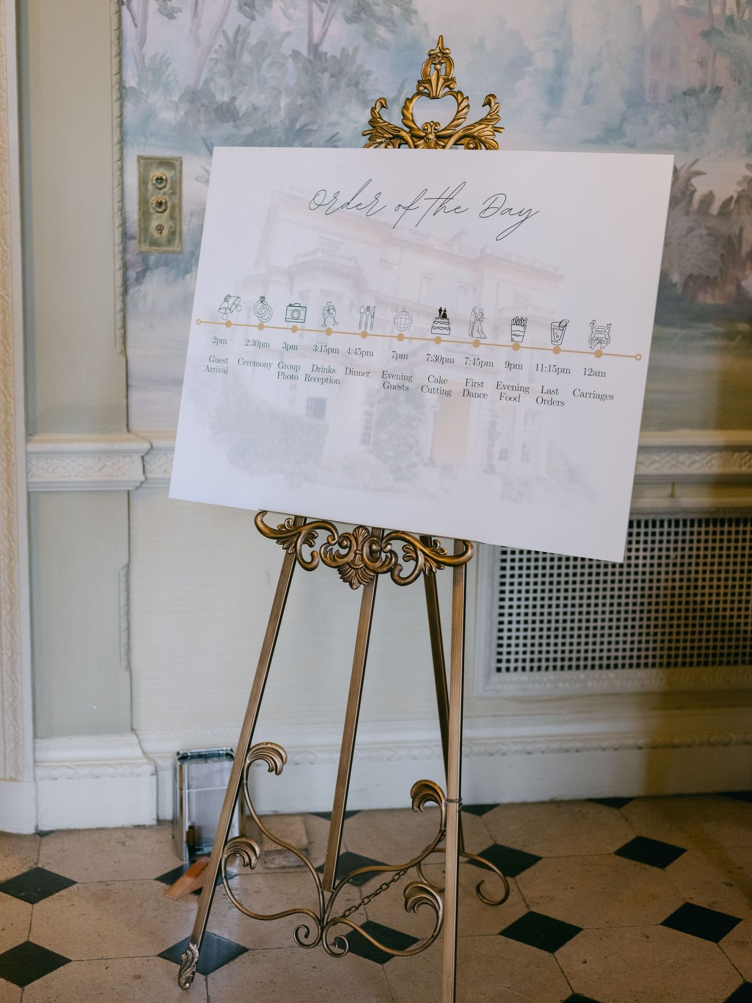 An ornate gold easel displays a wedding day timeline chart on white paper in an elegant indoor setting with tiled floors.