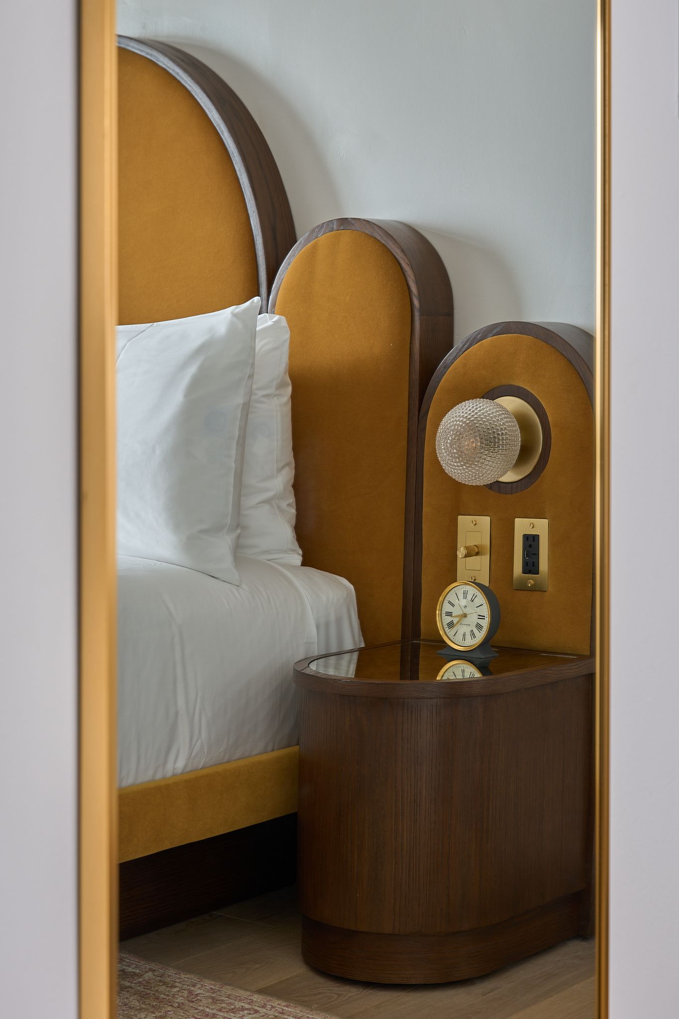 The guestroom at the Georgian Hotel in Santa Monica, LA. Interior Design by Fettle Design. Yellow fabric and nightstand