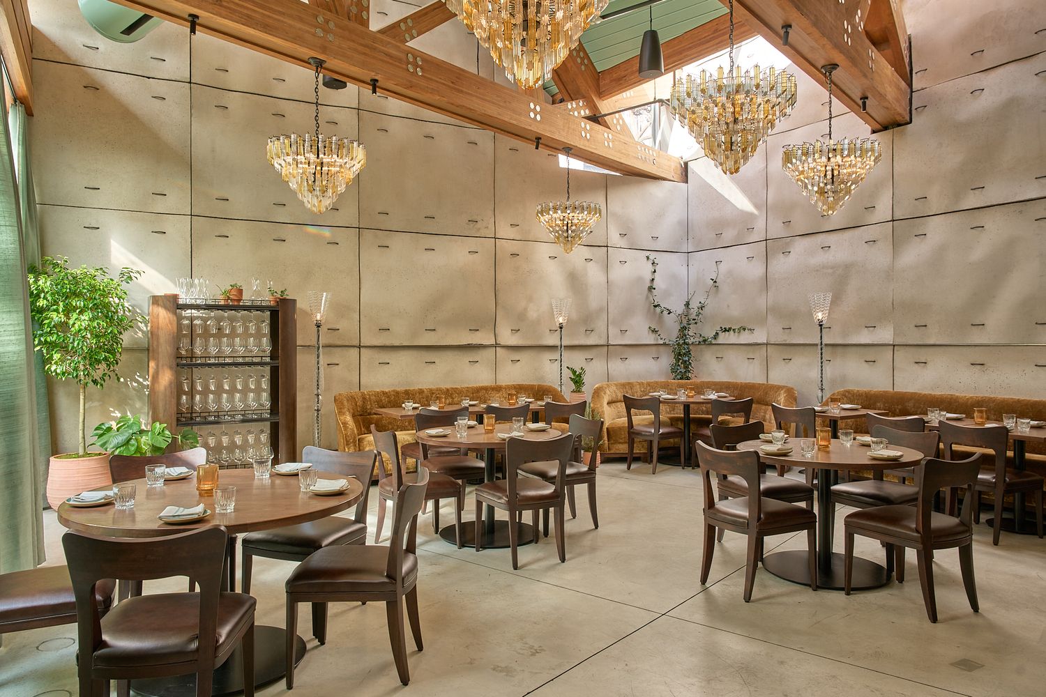 Interior photography of the dining room at Principe restaurant in Soho, NY. Designed by Studio Vogelsang. Concrete walls and yellow sofas