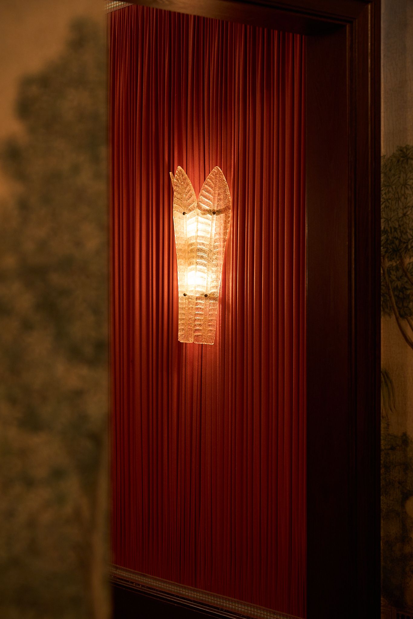 Detail of the wall lights by Sogni di Cristallo, on a pink fabric wall at the fifth ave hotel. Designed by MBDS