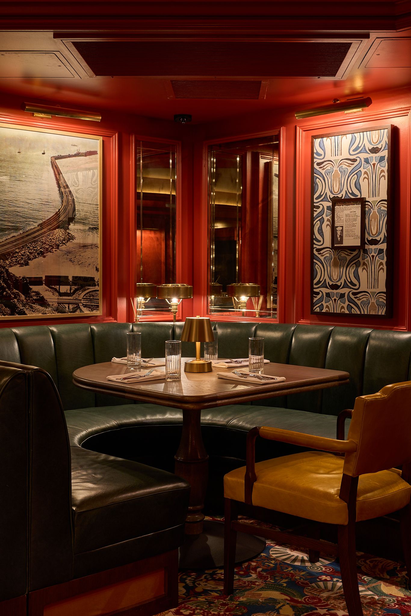 The georgian room at the Georgian Hotel in Santa Monica, LA. Interior Design by Fettle Design. Leather corner seat in red painted room.