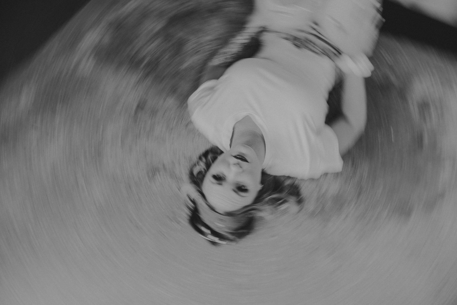 Black and white swirling photograph of a person in motion creating a spiral effect.