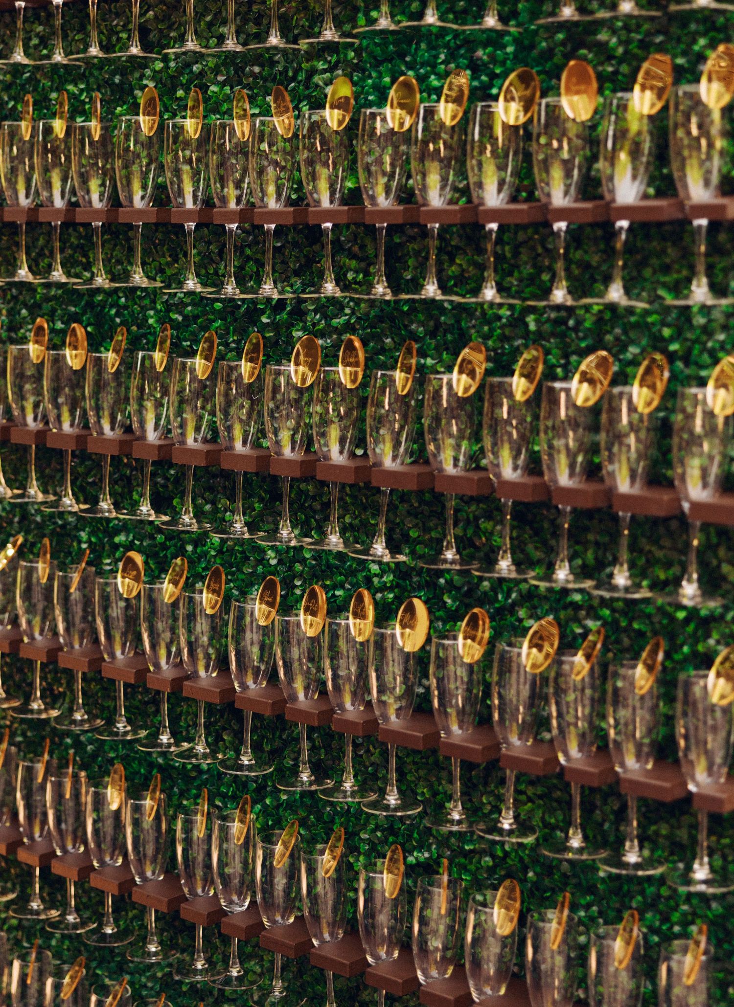 Rows of champagne glasses arranged in neat lines creating a mesmerizing pattern.