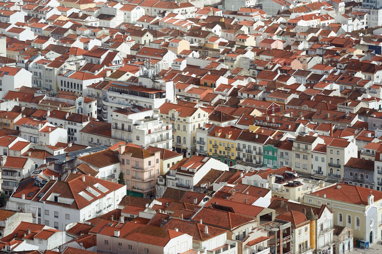 Bird's eye view of Porto's downtown showing tightly packed buildings with terracotta roofs.