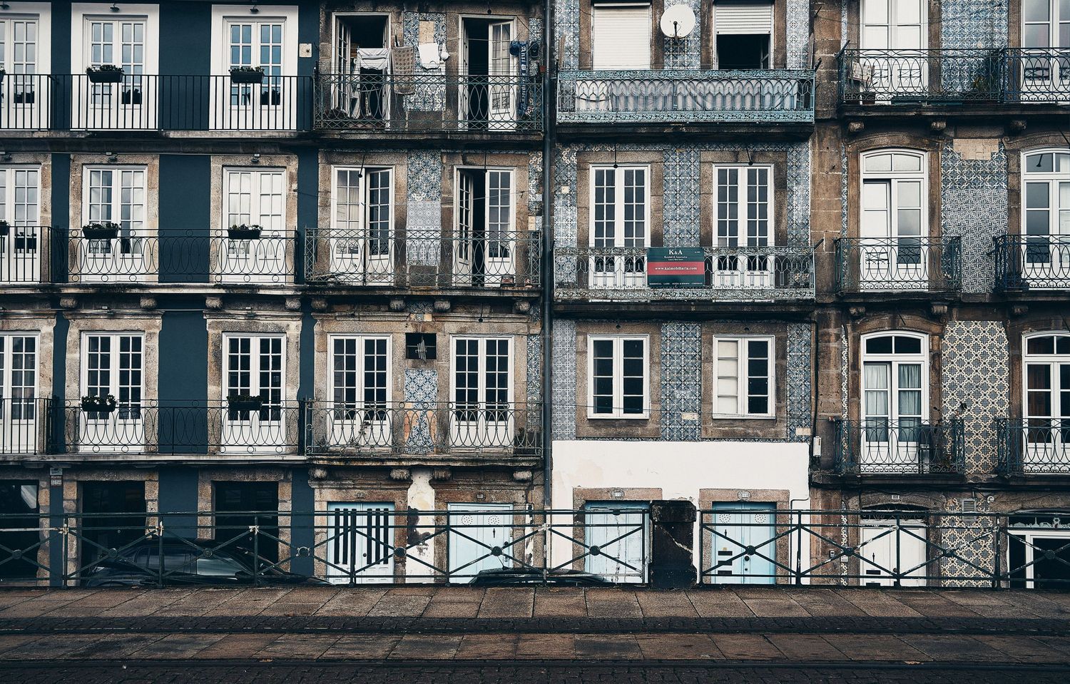 Traditional Portuguese apartment building facade with ornate balconies and detailed tilework.