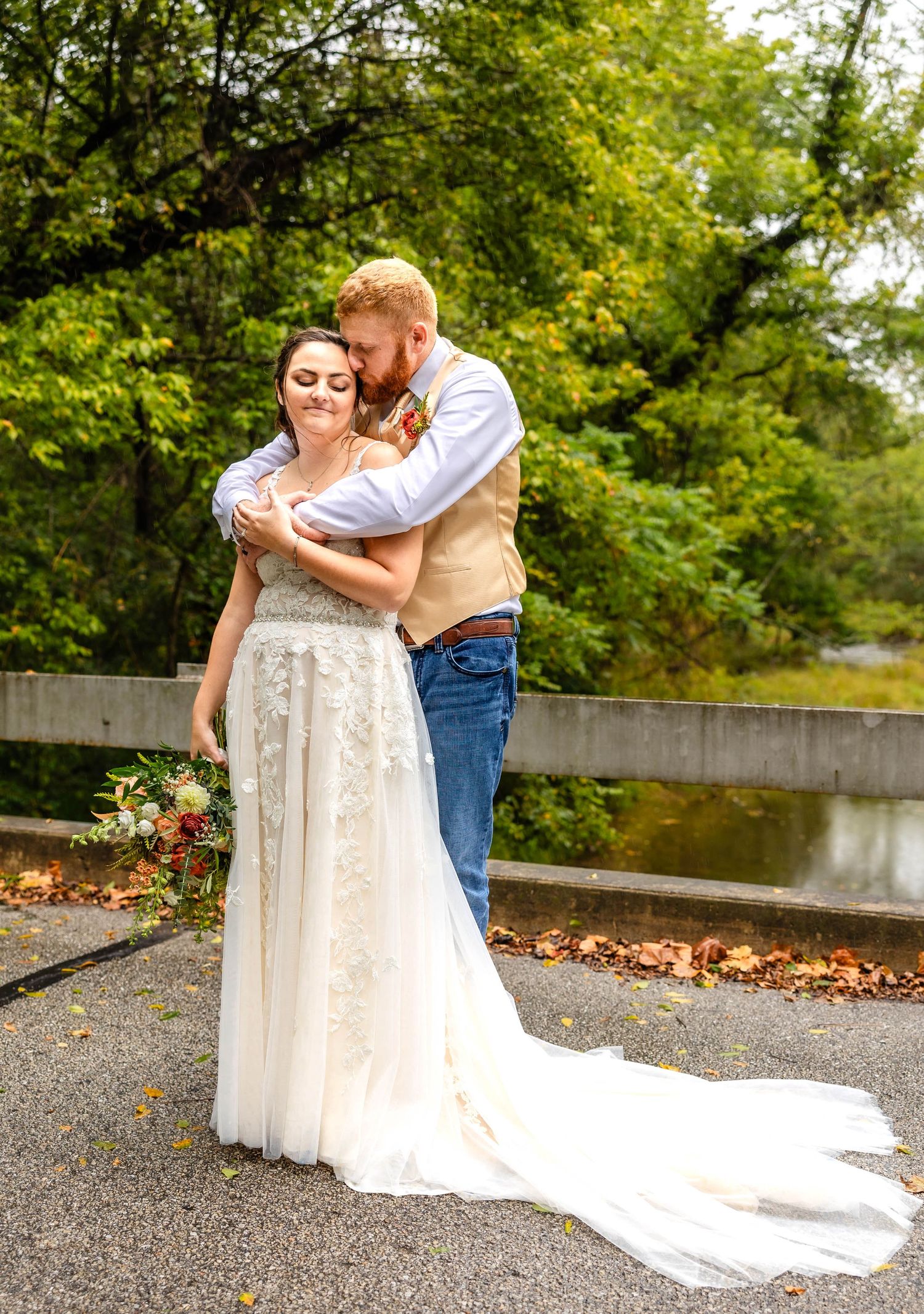A sweet embrace between newlyweds on their autumn wedding day.