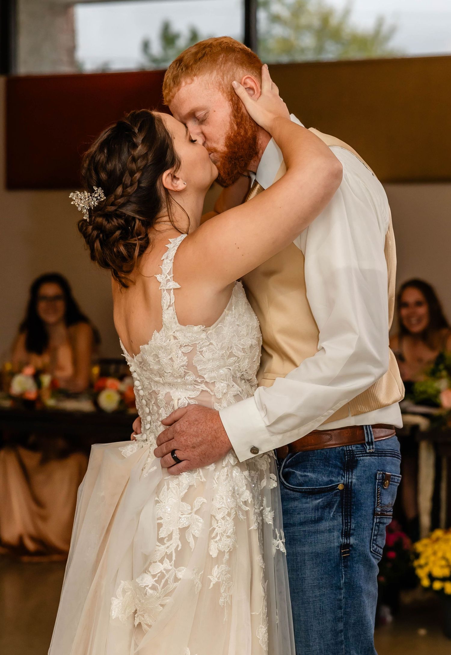 A romantic first dance moment at a rustic-themed wedding reception.