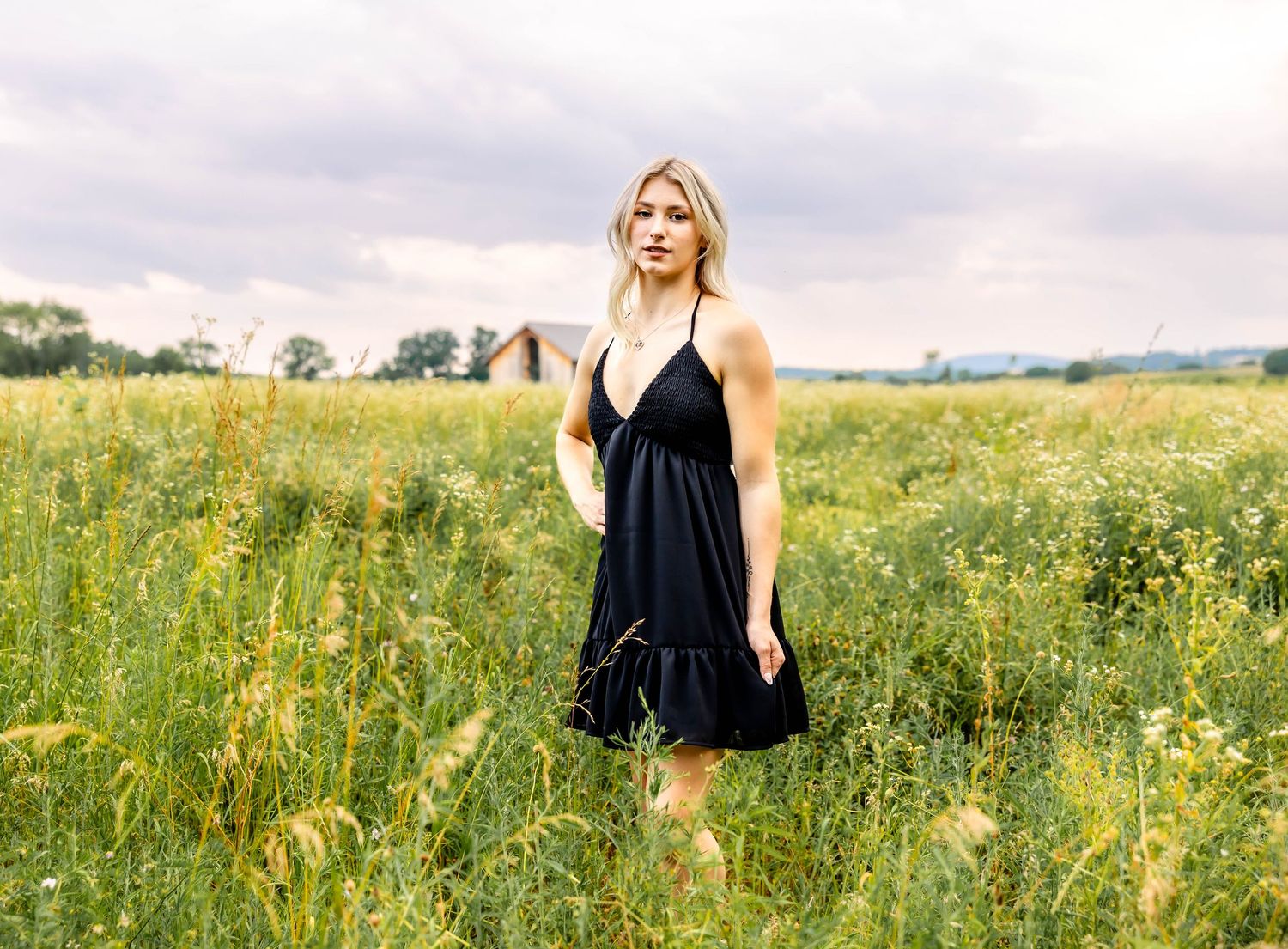 Black summer dress worn in a wildflower meadow during golden hour.