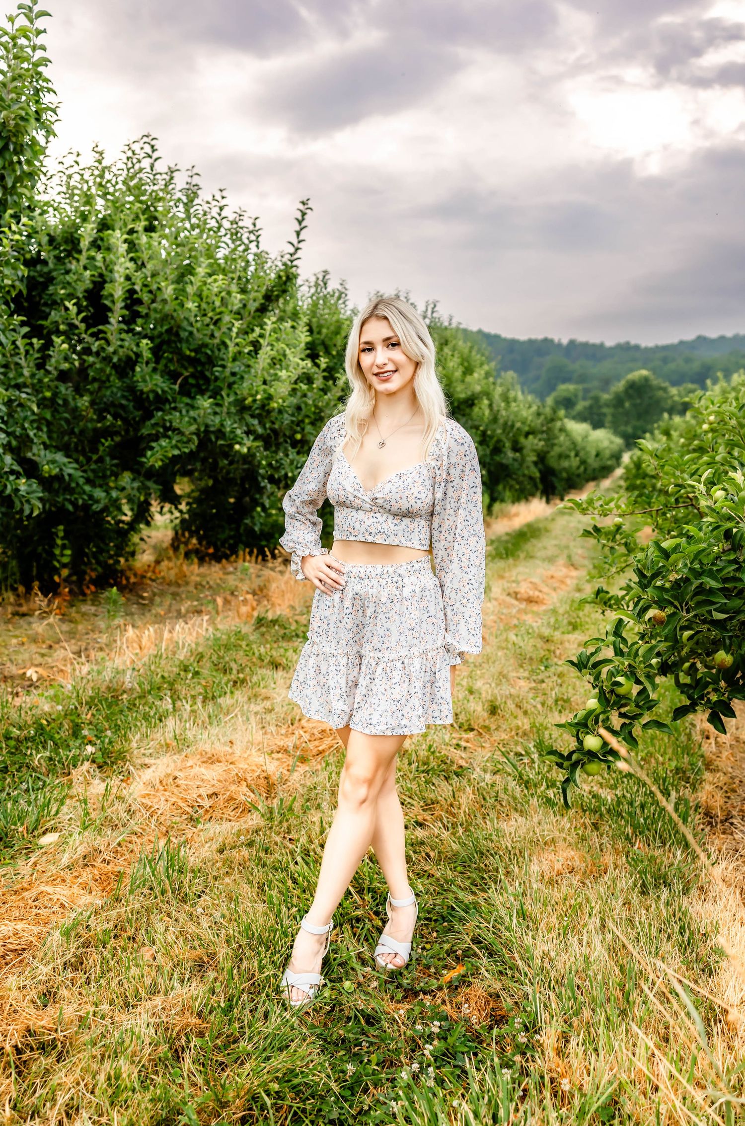 Floral two-piece outfit photographed in a scenic countryside setting.