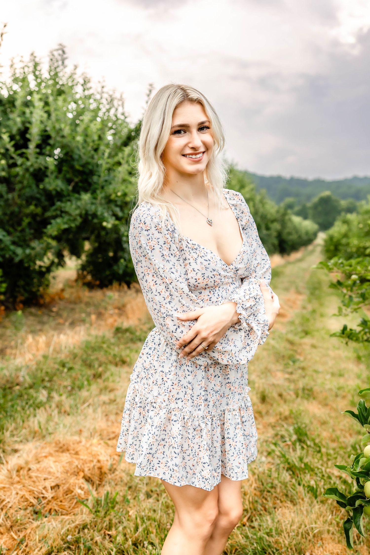 Floral summer dress photographed on a scenic hillside path.