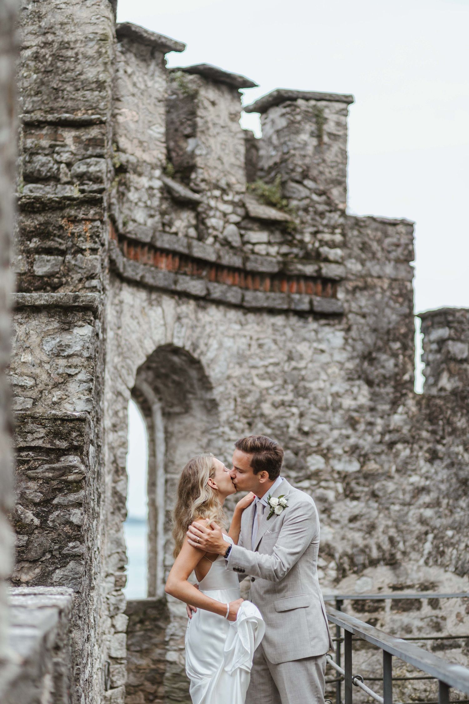 Romantic wedding portrait at historic stone castle ruins.