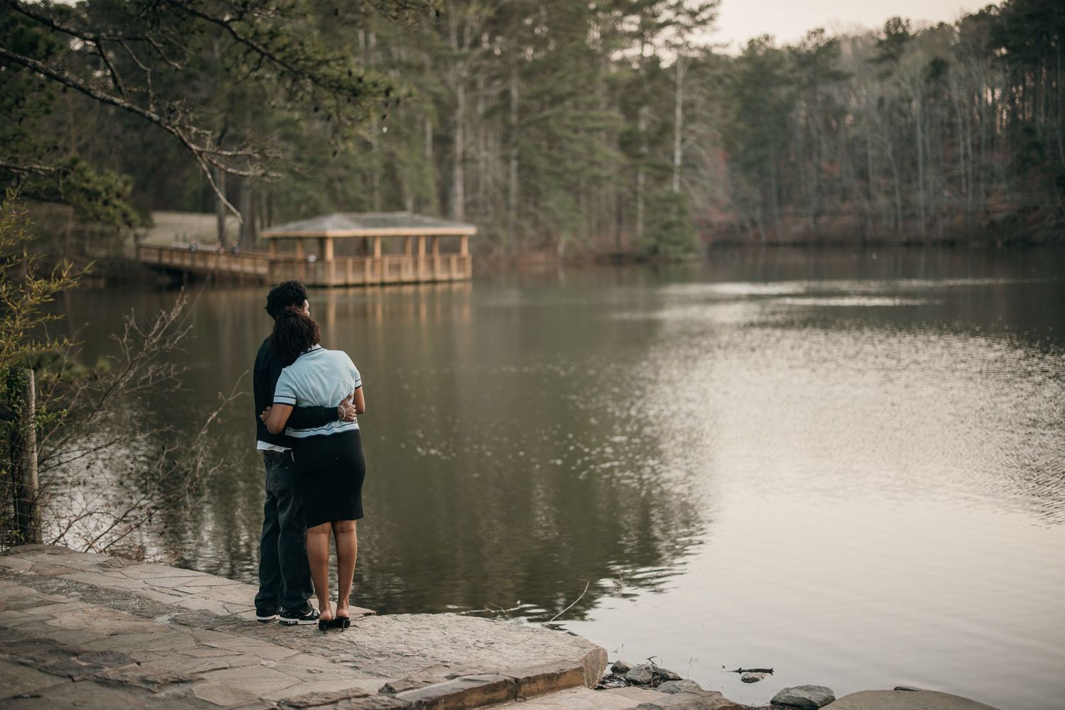 young black couple enjoying beautiful lake scenery. young black couple hugging, atlanta, gerogia