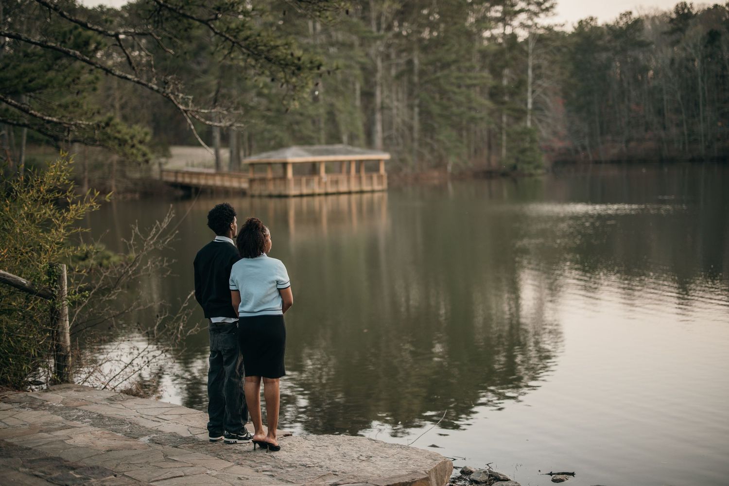 young black couple standing close together at edge of lake, romantic engagement photography at Sims Lake Park, romantic couples photography