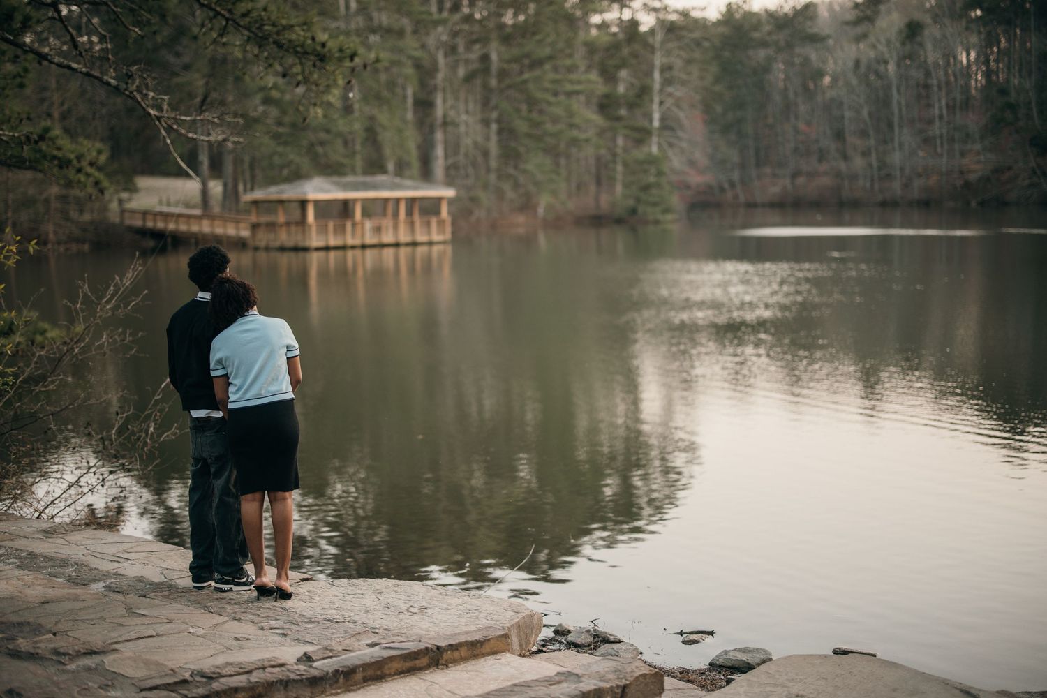 young black couple standing side by side looking at lake reflection, Sims Lake Park Suwanee documentary couples session